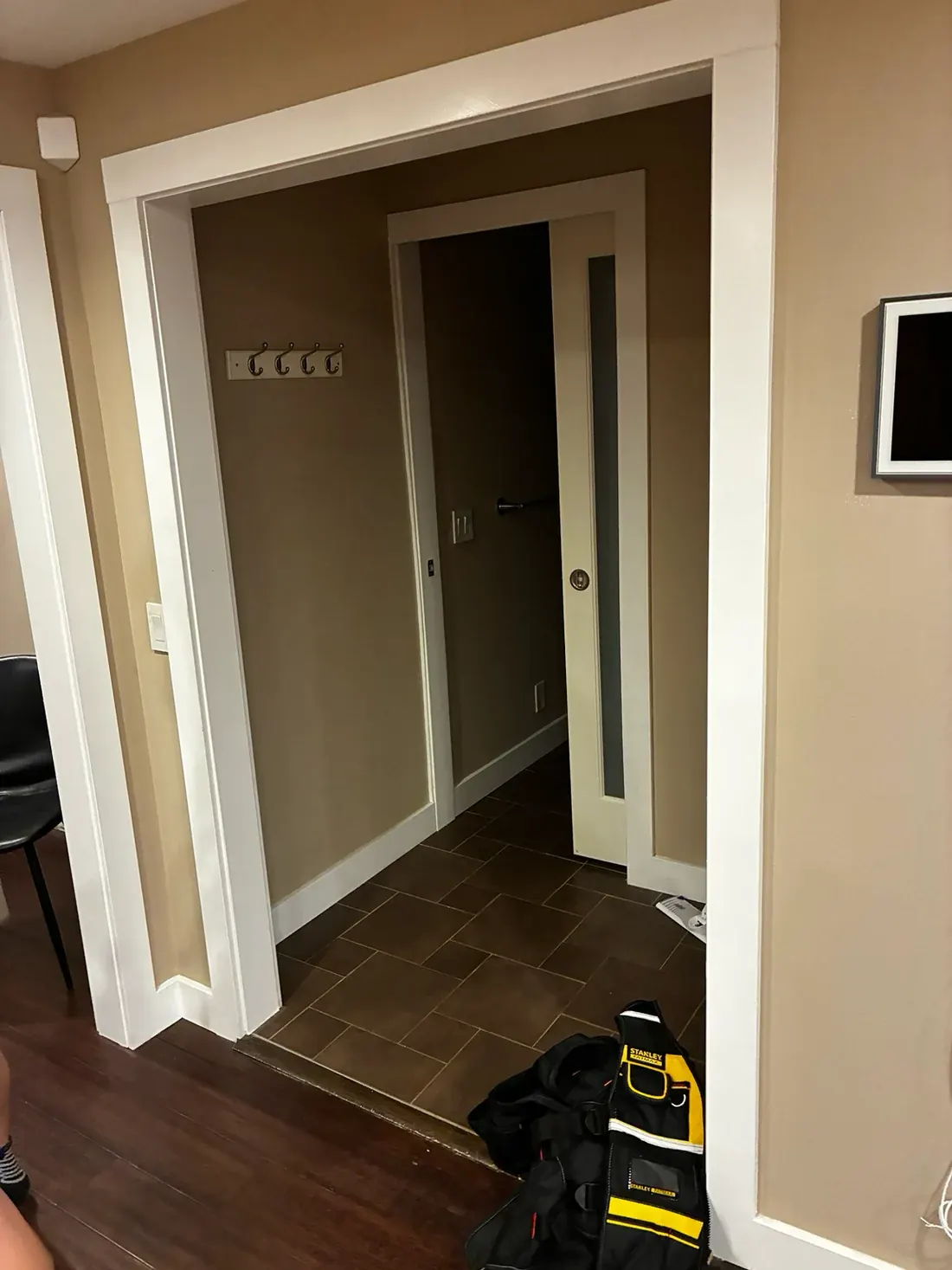 Before: dark taupe walls with white-painted door casings and a white pocket door